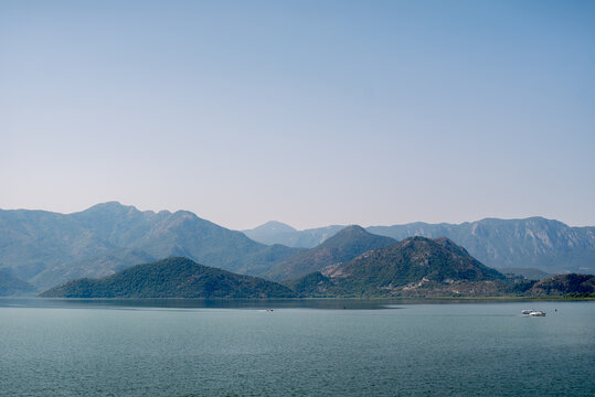 Calm bay with mountain range and small boat