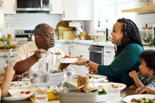 Family Enjoys Meal Together in the Kitchen
