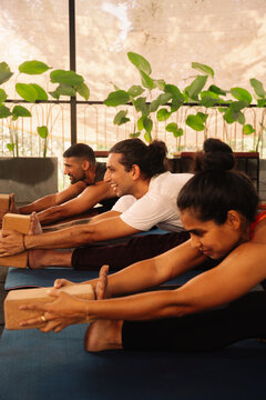 Yoga Class Focused on Stretching in a Bright Indoor Space
