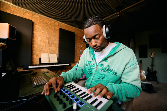 Music Producer Creating Music on MIDI Keyboard Controller Home Studio