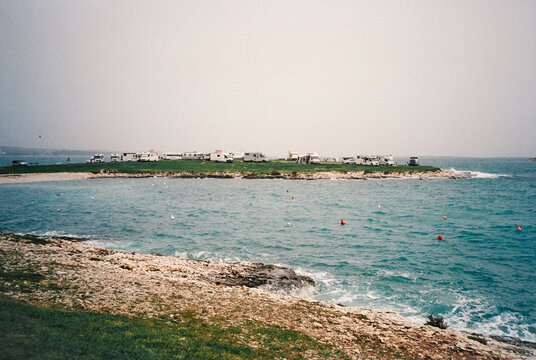 Campers parked on small coastal peninsula