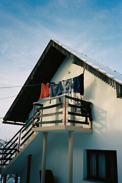 Snow covered house with balcony and hanging laundry