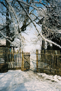 Open wooden gate in winter yard