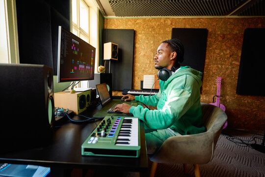 Black Music Producer Working in Professional Home Studio Environment