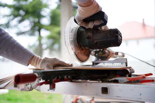 Woodworking process with a power saw at a job site