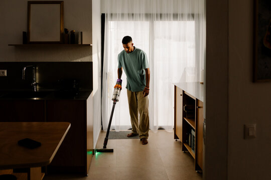 Modern man doing household chores during a productive day