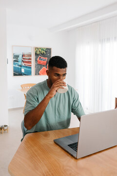 A solo entrepreneur works online while drinking coffee