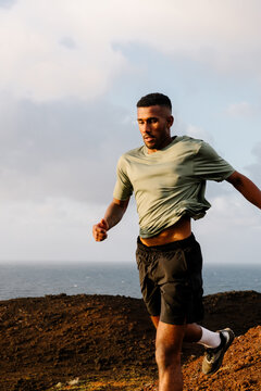Trail runner racing down a volcano during an outdoor training