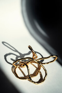 Gold Wire Sculpture on Table With Shadows in Afternoon Light