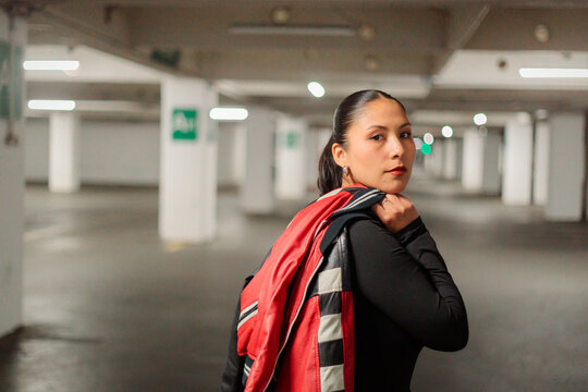 Portrait of Latina Woman With Jacket in Parking Lot