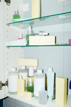 Close-up of a bathroom cabinet filled with beauty makeup skincare 