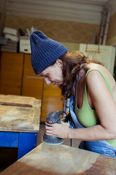 woman restoring furniture