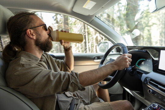 Road Trip Highway driving man drink water bottle