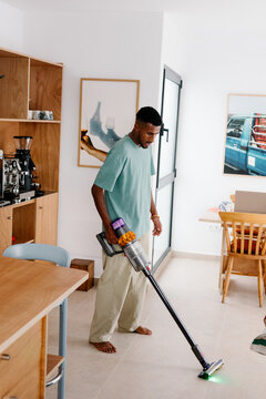 Modern man Balancing remote work with household tasks