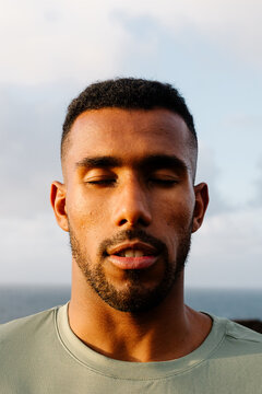 Athletic Black man with eyes shut and face focused