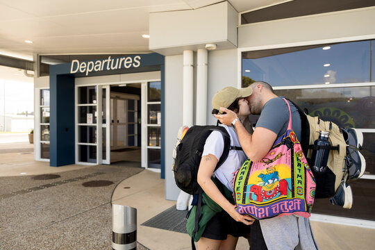 Couple kissing goodbye outside Ballina Airport Australia
