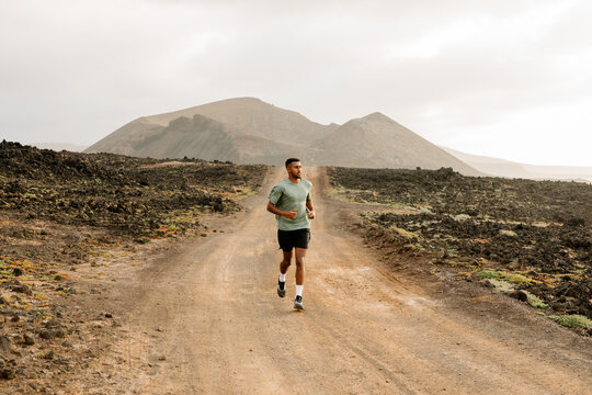 High-performance runner moving steadily along an unpaved trail
