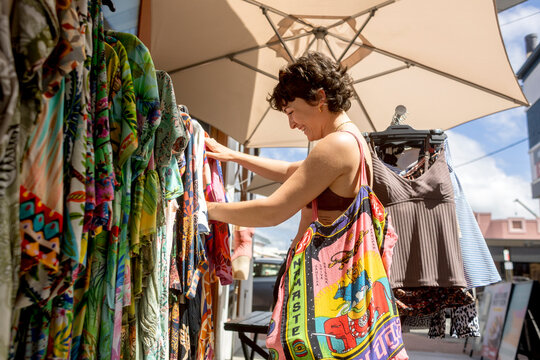 Woman browsing clothes at outdoor rack
