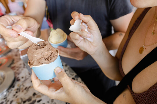Anonymous Couple eating ice cream indoors