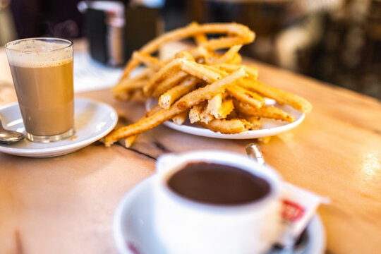 Cozy cafe breakfast with churros, hot chocolate and coffee cup