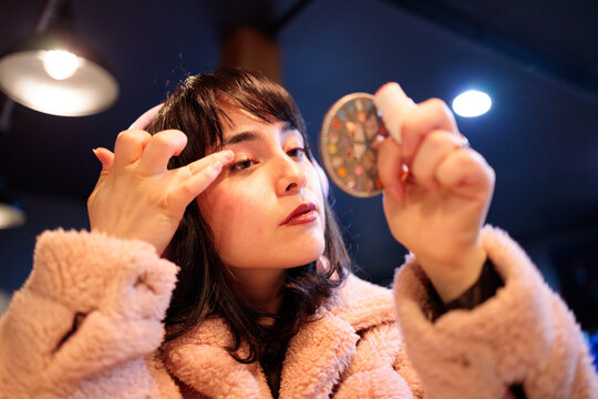 Woman doing makeup close up