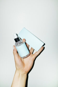 Cute luxurious baby blue bottle full of facial care beauty serum