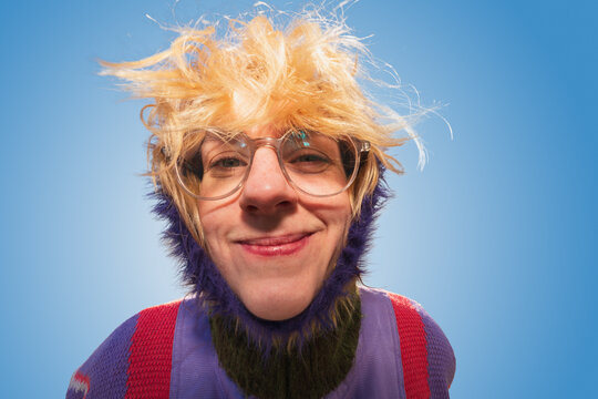 Playful close-up portrait of smiling woman with messy hair