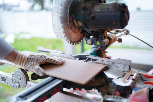Woodworking with a miter saw in a workshop