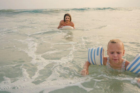 ather and Child in the Waves