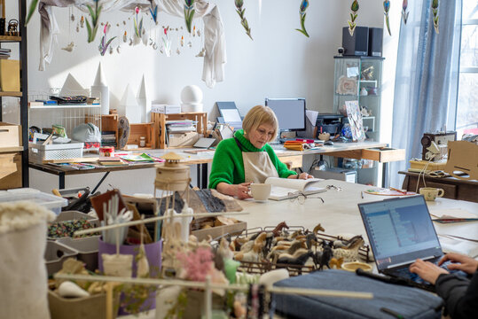 Female Artist Watch Drawing Book in Artist Studio