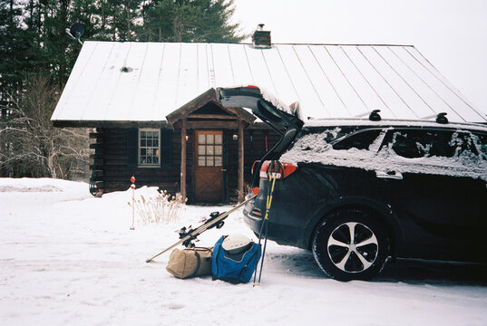 Vermont rustic Log Cabin Load ski gear in automobile vacation