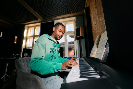 Black Musician Playing Piano Keyboard in Home Studio