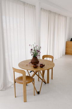 Small common area with large windows and long curtains