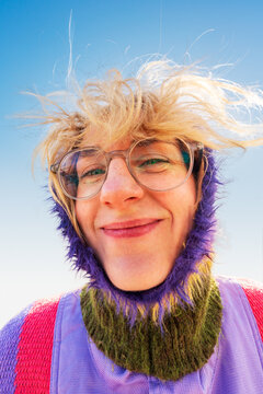 Close up portrait of smiling woman with windblown hair outdoors