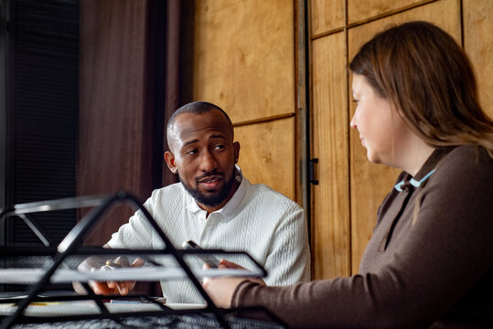 Two employees talk to each other in office