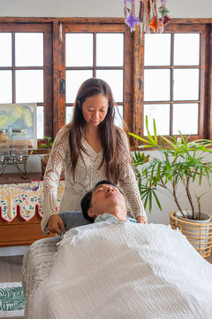 Person Provides Care During a Wellness Session at a Calm Location