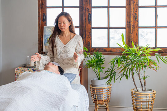 Woman Gives Wellness Treatment to a Person in Indoor Space