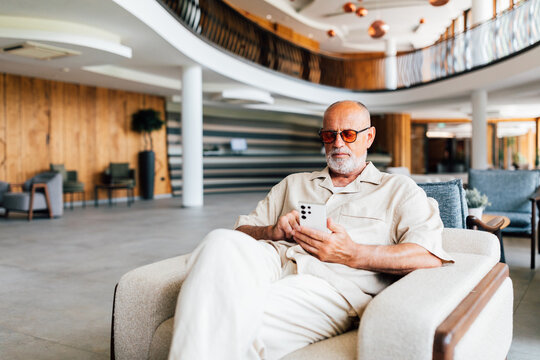 Business Senior Man on the Phone in Hotel Lounge