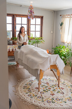 Woman Giving Massage in a Cozy Room With Plants and Natural Light