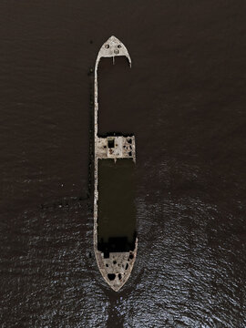 Aerial view of abandoned shipwreck in dark water