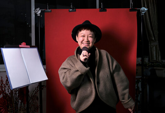Chinese woman sings joyfully at home during the Chinese New Year