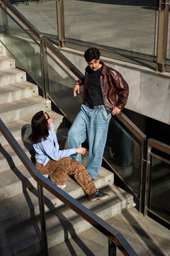 Couple talking on stairs in urban area during daytime