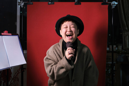 Chinese woman sings joyfully at home during the Chinese New Year