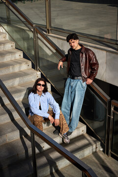 Couple sitting on stairs in urban setting during daylight