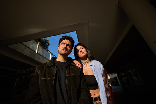 Couple standing together in urban setting during bright daylight