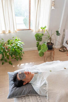 Person Resting With Eye Mask and Crystals in Indoor Space