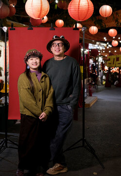 Chinese couple beneath a lantern tree in a garden&mdash;Chinese New Year