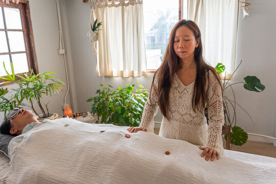 Woman Gives Healing Session in a Wellness Center in Daylight