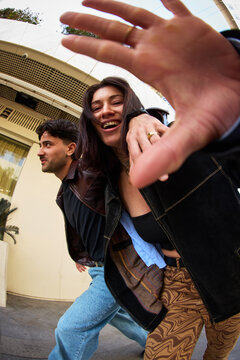 Couple enjoying time together on a city street while smiling