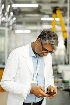  Indian scientist in white coat working in laboratory